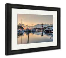 Load image into Gallery viewer, Framed Print, Hilton Head Island And Its Iconic Lighthouse Lit Up At Sunset With A Glass Like